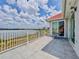 Balcony with chairs and a table that overlooks the lake and the surrounding landscape at 8515 Saint Marino Blvd, Orlando, FL 32836