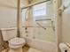Bathroom featuring a shower-tub combination with sliding glass doors at 8515 Saint Marino Blvd, Orlando, FL 32836