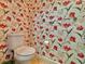 Powder room featuring floral wallpaper and a toilet at 8515 Saint Marino Blvd, Orlando, FL 32836