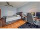 Bedroom with hardwood flooring, ceiling fan, sleigh bed, and dedicated work space at 8515 Saint Marino Blvd, Orlando, FL 32836