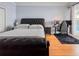 Bedroom with hardwood flooring, leather-bound sleigh bed, and dedicated work space at 8515 Saint Marino Blvd, Orlando, FL 32836