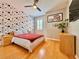 Bright bedroom with bamboo floors, fan, Mickey Mouse accent wall, and a queen-sized bed at 8515 Saint Marino Blvd, Orlando, FL 32836