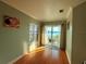 Inviting room with hardwood floors and a sliding glass door leading to an outdoor balcony with a view at 8515 Saint Marino Blvd, Orlando, FL 32836