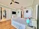 Spacious bedroom with a decorative ceiling fan, plush bed, and a walk-in closet for ample storage at 8515 Saint Marino Blvd, Orlando, FL 32836