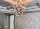 Elegant chandelier with crystal pendants, enhancing the stylish design and coffered ceiling at 8515 Saint Marino Blvd, Orlando, FL 32836