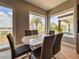 Bright dining area with a modern table, chairs, and expansive windows offering scenic views at 8515 Saint Marino Blvd, Orlando, FL 32836