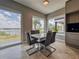 Bright dining area with a modern table, chairs, and expansive windows offering scenic views at 8515 Saint Marino Blvd, Orlando, FL 32836