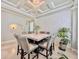 Refined dining room with a marble table, stylish high-backed chairs, a textured wall, and a modern chandelier at 8515 Saint Marino Blvd, Orlando, FL 32836
