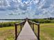 Picturesque dock leading to a gazebo, offering serene views of the water and lush surroundings at 8515 Saint Marino Blvd, Orlando, FL 32836