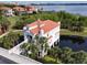 Unique waterfront home with a bridge entrance, private pond, and lush tropical landscaping at 8515 Saint Marino Blvd, Orlando, FL 32836