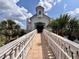 Quaint building with inviting pathway, surrounded by tropical landscaping and blue skies at 8515 Saint Marino Blvd, Orlando, FL 32836