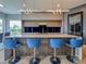 Sleek kitchen island with stylish bar stools and modern pendant lighting at 8515 Saint Marino Blvd, Orlando, FL 32836