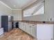 Kitchenette with stainless fridge, granite counters, and white cabinets at 8515 Saint Marino Blvd, Orlando, FL 32836