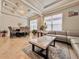 Bright living room with a modern gray sofa, marble coffee table, statement wall, and elegant chandelier at 8515 Saint Marino Blvd, Orlando, FL 32836