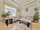 Bright living room showcasing a neutral sofa, stylish marble tables, and eye-catching artwork at 8515 Saint Marino Blvd, Orlando, FL 32836