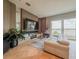 Modern living room with a sleek entertainment center, comfortable seating, and sliding glass doors leading to a balcony at 8515 Saint Marino Blvd, Orlando, FL 32836