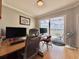 Home office featuring a large desk, dual monitors, balcony access, and views of the water at 8515 Saint Marino Blvd, Orlando, FL 32836