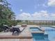 Beautiful backyard pool with a hot tub, fire pit, two lounge chairs, and an amazing view at 8515 Saint Marino Blvd, Orlando, FL 32836