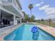 Beautiful backyard pool with a lounge chair and grill, overlooking the lake at 8515 Saint Marino Blvd, Orlando, FL 32836