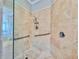Modern tiled shower with glass doors and chrome fixtures, providing a spa-like experience at 8515 Saint Marino Blvd, Orlando, FL 32836