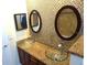 Bathroom with double vessel sinks, granite countertops, and mosaic tile accents for a modern look at 8613 Edge O Woods Ct, Orlando, FL 32819