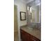 Bathroom vanity with stylish granite countertops and a unique vessel sink, complemented by mosaic tile accents at 8613 Edge O Woods Ct, Orlando, FL 32819