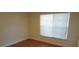 Bright bedroom with a large window, hardwood floors, and neutral-colored walls at 8613 Edge O Woods Ct, Orlando, FL 32819