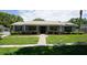 Charming single-story home featuring a manicured front lawn and inviting entrance at 8613 Edge O Woods Ct, Orlando, FL 32819
