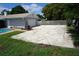 View of the side of the house with large parking area and gray garage at 8613 Edge O Woods Ct, Orlando, FL 32819