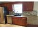 Kitchen with granite counters, stylish backsplash, and modern stainless steel appliances at 8613 Edge O Woods Ct, Orlando, FL 32819
