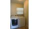 Bright laundry room features new washer and dryer, and window with natural light at 8613 Edge O Woods Ct, Orlando, FL 32819