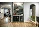 Custom bar nook features shelving and a beverage fridge, perfect for entertaining guests at 9208 Chandler Dr, Groveland, FL 34736