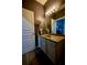 The bathroom has a marble vanity, soft lighting, and cool purple walls at 9208 Chandler Dr, Groveland, FL 34736