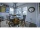 Dining room with a unique barrel table, soft chairs, decor, and a light gray rug underfoot at 9208 Chandler Dr, Groveland, FL 34736