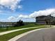 Beautiful lakefront property features a two-story home with an attached garage and professionally maintained lawn at 9208 Chandler Dr, Groveland, FL 34736