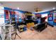 Spacious entertainment space with superhero artwork, a yellow media center, and an oversized dragon figure at 9208 Chandler Dr, Groveland, FL 34736