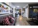 Inviting hallway with wood floors, wall decor, and a purple bench leading to the home's living spaces and staircase at 9208 Chandler Dr, Groveland, FL 34736