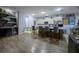 Spacious kitchen with seating at the island, stainless steel appliances, and a well-lit bar area at 9208 Chandler Dr, Groveland, FL 34736