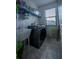 Bright laundry room with a large washing machine, sink, and window at 9208 Chandler Dr, Groveland, FL 34736