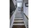 Elegant staircase with hardwood treads, white risers, and railing at 9208 Chandler Dr, Groveland, FL 34736