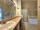 Bathroom featuring double sinks, shower, bath, and decorative tile at 928 Chanler Dr, Haines City, FL 33844