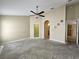 Bedroom with ceiling fan, neutral walls, and doorways to closets and ensuite bathroom at 928 Chanler Dr, Haines City, FL 33844
