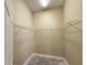 Walk-in closet with wire shelving and bare floors in need of carpet or refinishing at 928 Chanler Dr, Haines City, FL 33844