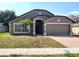 Charming single-story home with a two-car garage and well-maintained landscaping, creating excellent curb appeal at 928 Chanler Dr, Haines City, FL 33844