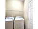 Bright laundry room with a washer, dryer, and wire shelving for storage at 928 Chanler Dr, Haines City, FL 33844