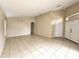 Spacious living room with tile flooring, neutral walls, and open access to other rooms at 928 Chanler Dr, Haines City, FL 33844