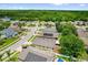 Beautiful aerial view of a suburban neighborhood with mature trees and a lake in the distance at 9871 Nonacrest Dr, Orlando, FL 32832