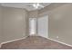 Carpeted bedroom with closet and view to hall at 9871 Nonacrest Dr, Orlando, FL 32832
