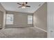 Spacious carpeted bedroom features a ceiling fan, two windows, and neutral paint at 9871 Nonacrest Dr, Orlando, FL 32832