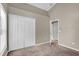 Carpeted bedroom featuring a closet and view to hall at 9871 Nonacrest Dr, Orlando, FL 32832